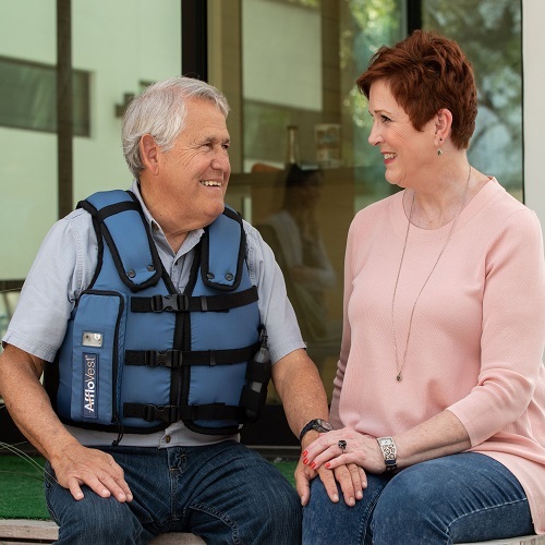 Man wearing AffloVest sitting outside with woman